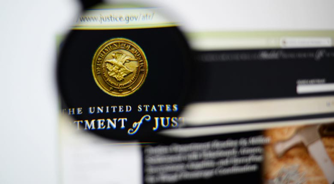 Close-up of the U.S. Department of Justice website with the Department of Justice seal magnified and in focus