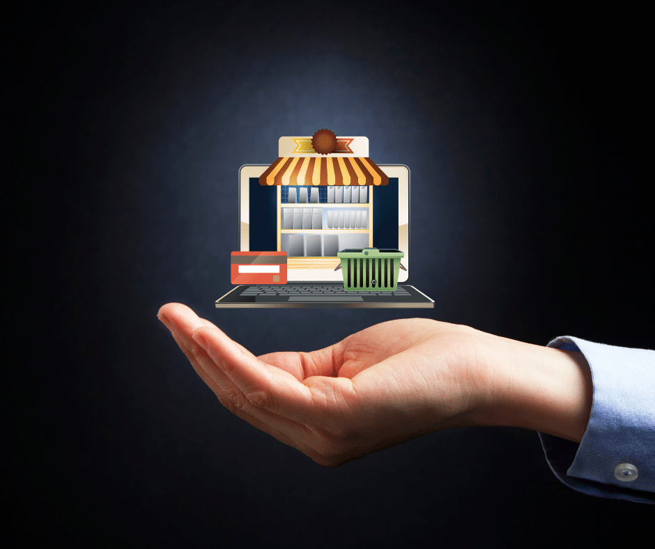 the image of a brick and mortar storefront rest atop an open laptop, all of which hovers above the palm of a human hand