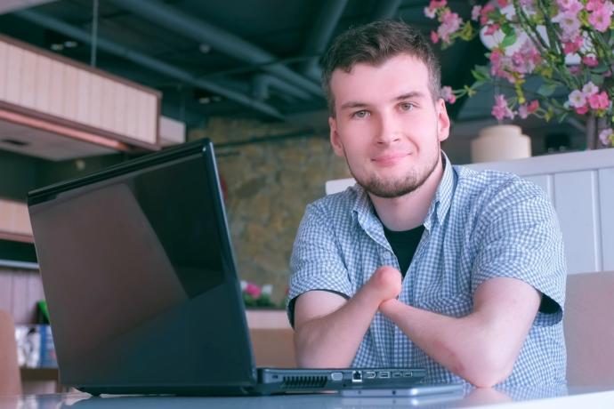 person with disability sitting in front of laptop