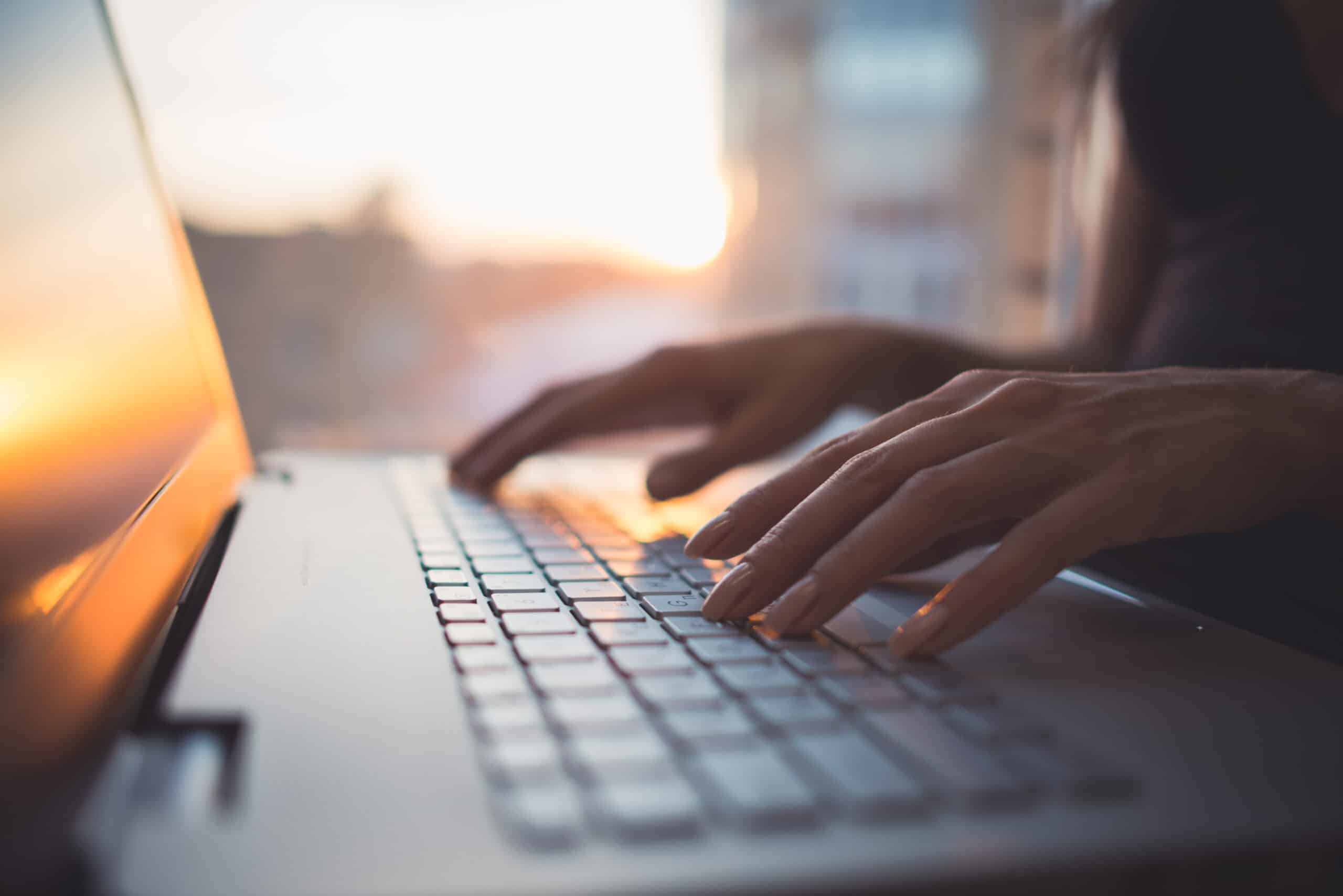 woman typing on laptop