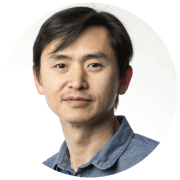 A headshot of Che-Bin Liu, Director of Software Engineering at Socure. He has short black hair and a moustache, and a serious expression.