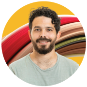 A headshot of Nir Ben-Yair, Front End Team Lead at Gloat. He has short, curly brown hair and a beard, and is wearing a pale green t-shirt.