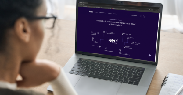 The profile of a woman viewing a laptop screen, which displays the Level Access website. On the website, text reads: All the tools, services, and insights you need. All in one place. Below the text is a diagram showing Level Access's core platform capabilities and services.
